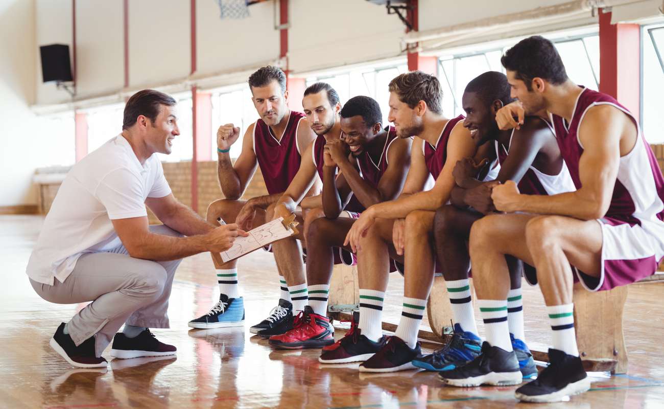 basketball players and coach having a teamtalk