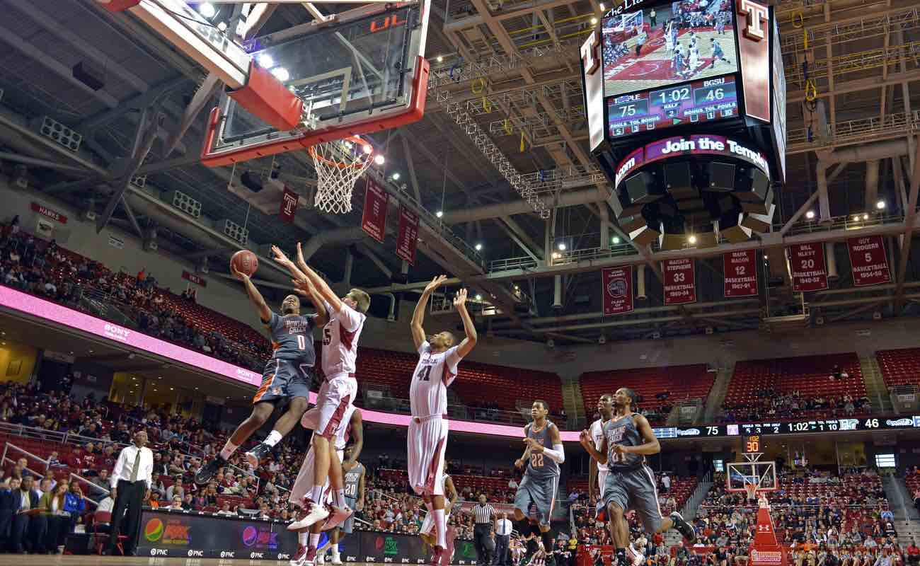 Bowling Green State University’s Spencer Parker goes in for a shot as Temple player defends during a basketball game 