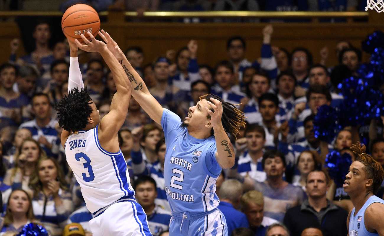 Cole Anthony of North Carolina Tar Heels challenges a shot by Tre Jones of Duke Blue Devils during game at Cameron Indoor Stadium