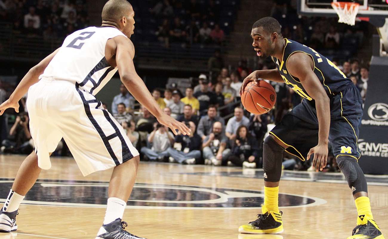 Michigan's Tim Hardaway brings the ball up the court against Penn State