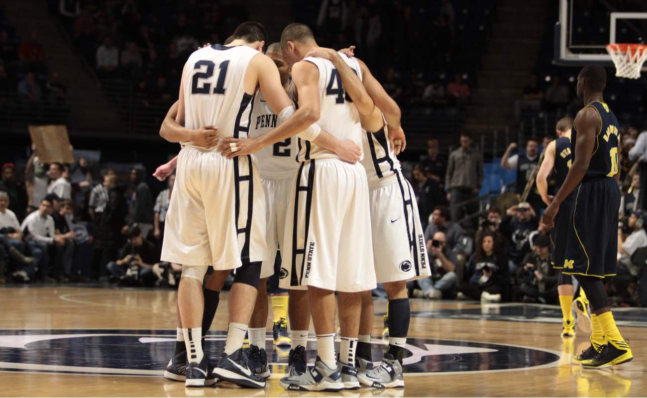 Penn State's players gather at mid-court before a basketball game