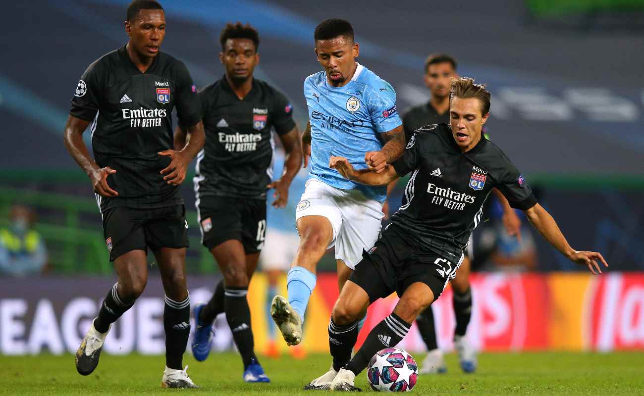 Maxence Caqueret of Lyon tackles Manchester City’s Gabriel Jesus