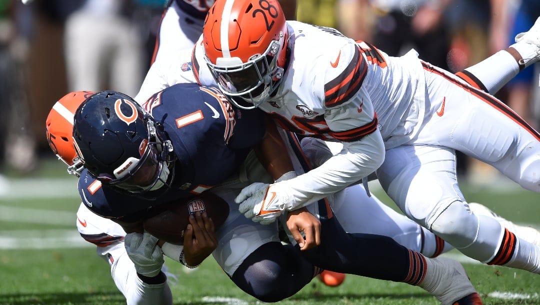 Chicago Bears quarterback Justin Fields (1) is sacked by Cleveland Browns linebacker Jeremiah Owusu-Koramoah (28) and defensive end Myles Garrett during an NFL football game, Sunday, Sept. 26, 2021, in Cleveland. The Browns won 26-6. (AP Photo/David Richard)