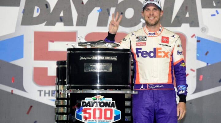 ALT - DAYTONA BEACH, FLORIDA - FEBRUARY 17: Denny Hamlin, driver of the #11 FedEx Express Toyota, poses with the trophy in Victory Lane after winning the NASCAR Cup Series 62nd Annual Daytona 500 at Daytona International Speedway on February 17, 2020, in Daytona Beach, Florida. (Photo by Jared C. Tilton/Getty Images)