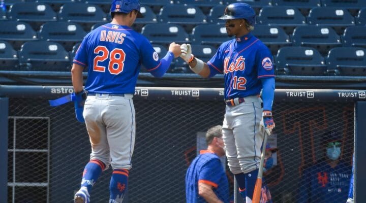 J.D. Davis #28 of the New York Mets is congratulated by Francisco Lindor #12 after scoring in the sixth inning of a spring training game against the Washington Nationals at The Ballpark of The Palm Beaches on March 21, 2021, in West Palm Beach, Florida. (Photo by Eric Espada/Getty Images)