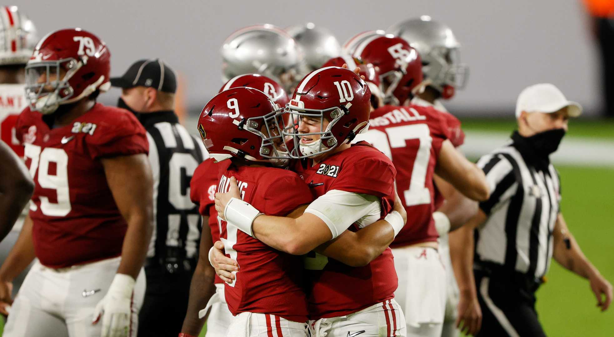 Mac Jones #10 of the Alabama Crimson Tide hugs Bryce Young #9 after being taken out of the game during the fourth quarter against the Ohio State Buckeyes of the College Football Playoff National Championship game at Hard Rock Stadium on January 11, 2021 in Miami Gardens, Florida. (Photo by Sam Greenwood/Getty Images)