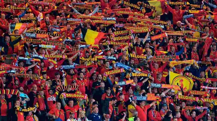 Fans in a stadium holding up scarves for Belgium and Scotland - Photo credit ANDY BUCHANAN/AFP via Getty Images