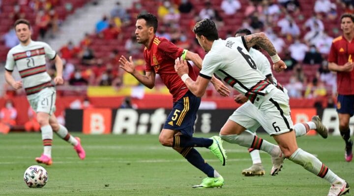 Spain's midfielder Sergio Busquets (L) is challenged by Portugal's defender Jose Fonte during the international friendly football match between Spain and Portugal at the Wanda Metropolitano stadium in Madrid in preparation for the UEFA European Championships, on June 4, 2021. (Photo by JAVIER SORIANO/AFP via Getty Images)