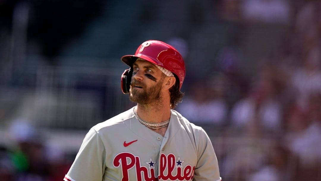 Philadelphia Phillies designated hitter Bryce Harper (3) walks off the field after striking out in the first inning of a baseball game against the Atlanta Braves, Saturday, May 27, 2023, in Atlanta. (AP Photo/Brynn Anderson)