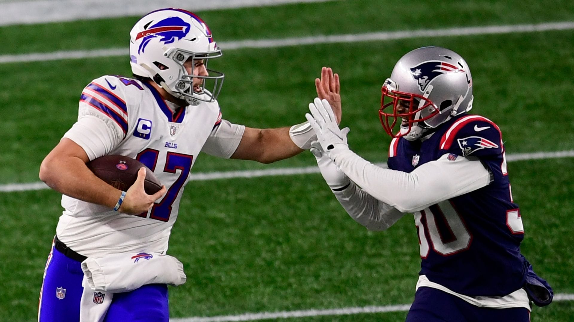 FOXBOROUGH, MASSACHUSETTS - DECEMBER 28: Josh Allen #17 of the Buffalo Bills runs the ball against Jason McCourty #30 of the New England Patriots at Gillette Stadium on December 28, 2020 in Foxborough, Massachusetts. (Photo by Maddie Malhotra/Getty Images)