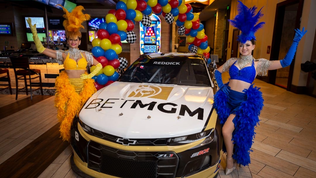 BetMGM Chevrolet with two dancers at the opening of BetMGM Sportsbook at Vee Quiva