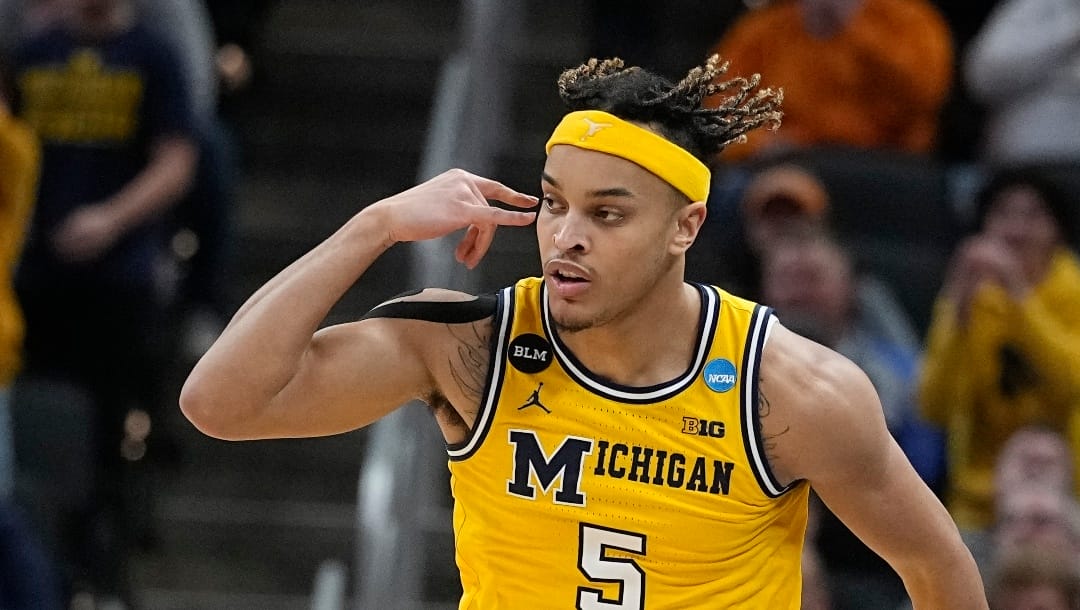 Michigan's Terrance Williams II reacts after hitting a basket during the first half of a college basketball game against Tennessee in the second round of the NCAA tournament, Saturday, March 19, 2022, in Indianapolis. (AP Photo/Darron Cummings)
