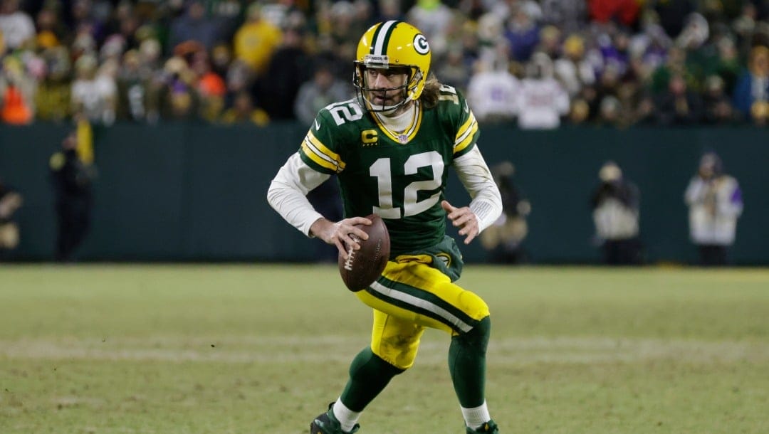 Green Bay Packers' Aaron Rodgers runs for a first down during the second half of an NFL football game against the Minnesota Vikings Sunday, Jan. 2, 2022, in Green Bay, Wis. (AP Photo/Matt Ludtke)