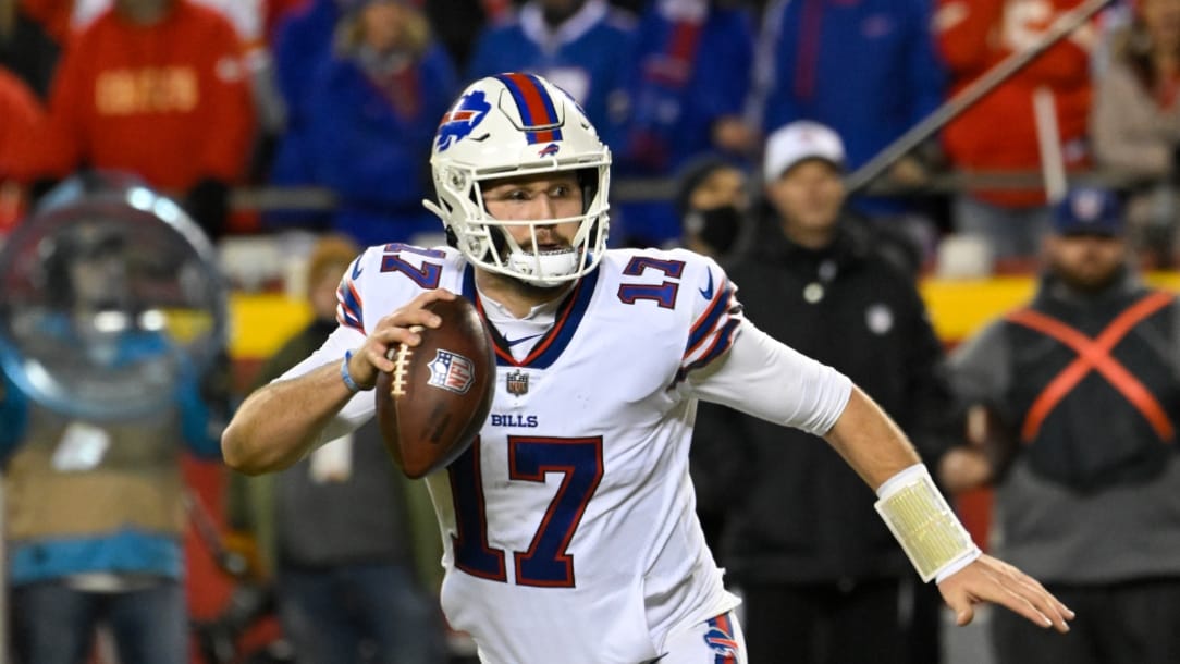 Buffalo Bills quarterback Josh Allen scrambles away from pressure before throwing for a two-point conversion during the second half of an NFL divisional playoff football game against the Kansas City Chiefs, Sunday, Jan. 23, 2022 in Kansas City, Mo. (AP Photo/Reed Hoffmann)