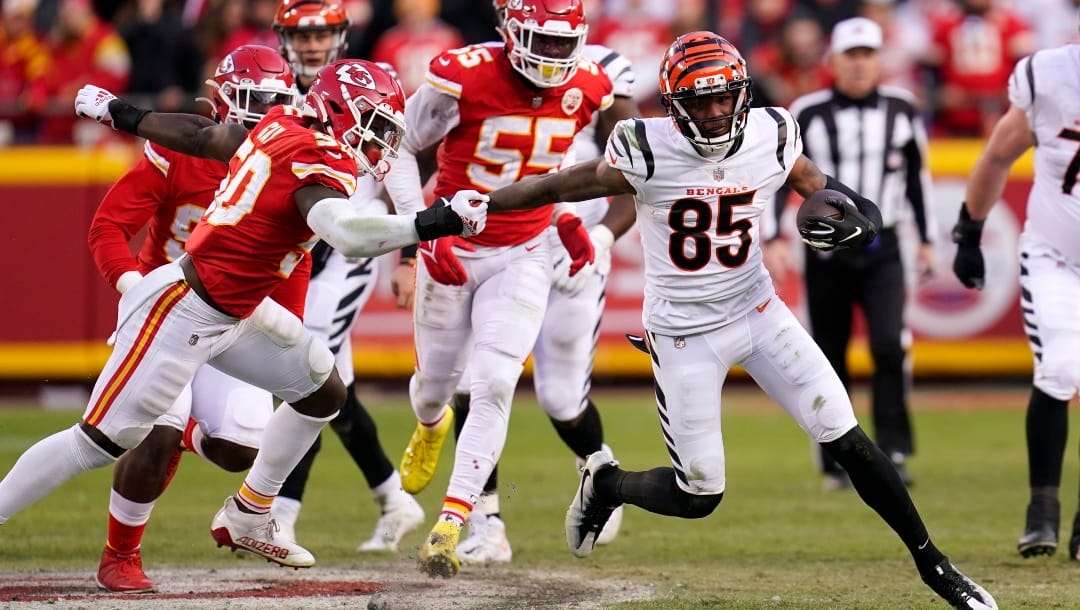 Cincinnati Bengals wide receiver Tee Higgins (85) escapes a tackle attempt from Kansas City Chiefs middle linebacker Willie Gay Jr., left, after catching a pass during the second half of the AFC championship NFL football game, Sunday, Jan. 30, 2022, in Kansas City, Mo. (AP Photo/Paul Sancya)