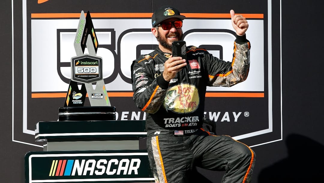 Martin Truex Jr gives a thumbs up to fans as he takes a picture in Victory Lane after winning a NASCAR Cup Series auto race at Phoenix Raceway, Sunday, March 14, 2021, in Avondale, Ariz. (AP Photo/Ralph Freso)