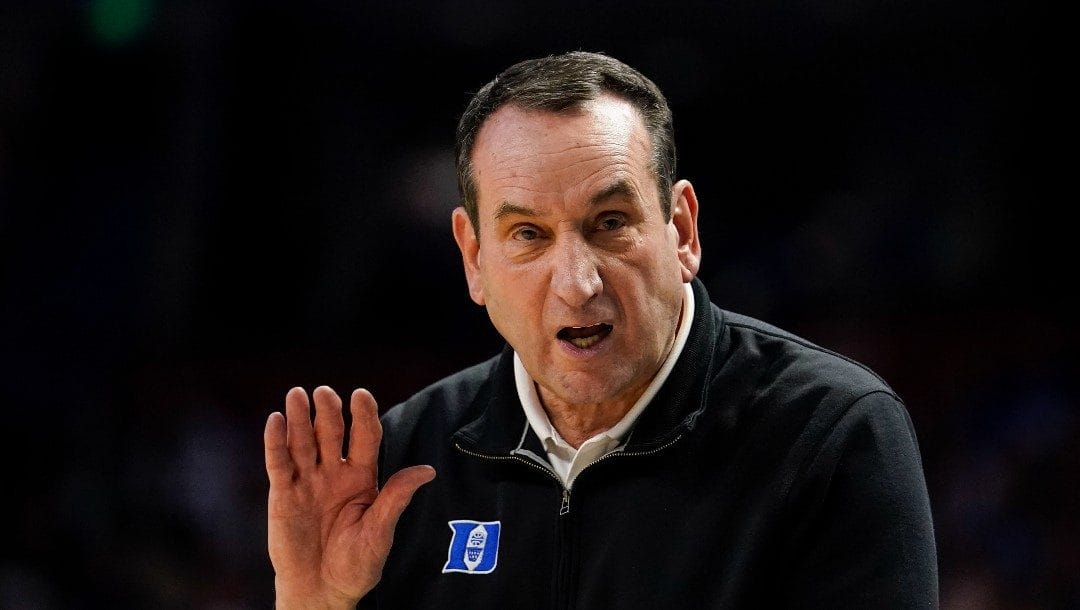 Duke head coach Mike Krzyzewski yells towards the team during the first half of a college basketball game in the second round of the NCAA tournament against Michigan State, Sunday, March 20, 2022, in Greenville, S.C.