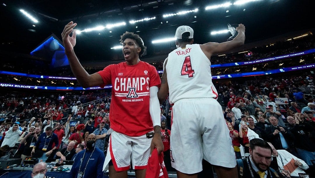 Arizona's Justin Kier, left, and Dalen Terry (4) celebrate after defeating UCLA in an NCAA college basketball game in the championship of the Pac-12 tournament Saturday, March 12, 2022, in Las Vegas.