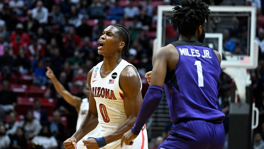 Arizona guard Bennedict Mathurin (0) reacts to a play next to TCU guard Mike Miles (1) after during the second half of a second-round NCAA college basketball tournament game, Sunday, March 20, 2022, in San Diego. Arizona beat TCU 85-80 in overtime.