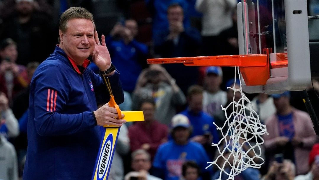 Kansas head coach Bill Self cuts down the net after a college basketball game in the Elite 8 round of the NCAA tournament against Miami Sunday, March 27, 2022, in Chicago. Kansas won 76-50 to advance to the Final Four.