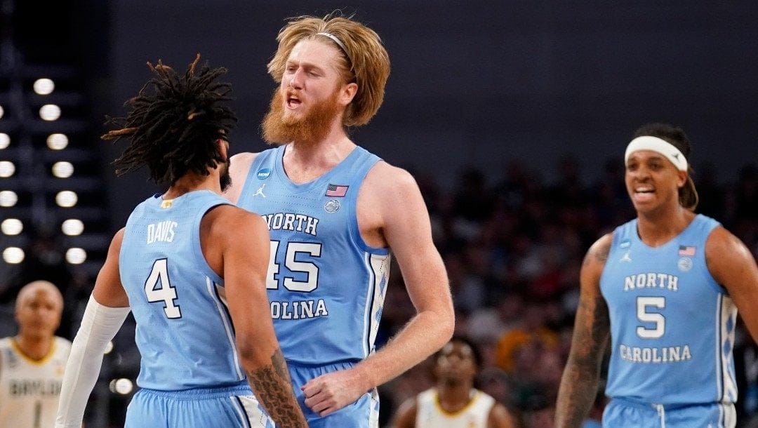 North Carolina guard RJ Davis (4), forward Brady Manek (45) and forward Armando Bacot (5) celebrate in the second half of a second-round game against Baylor in the NCAA college basketball tournament in Fort Worth, Texas, Saturday, March, 19, 2022.