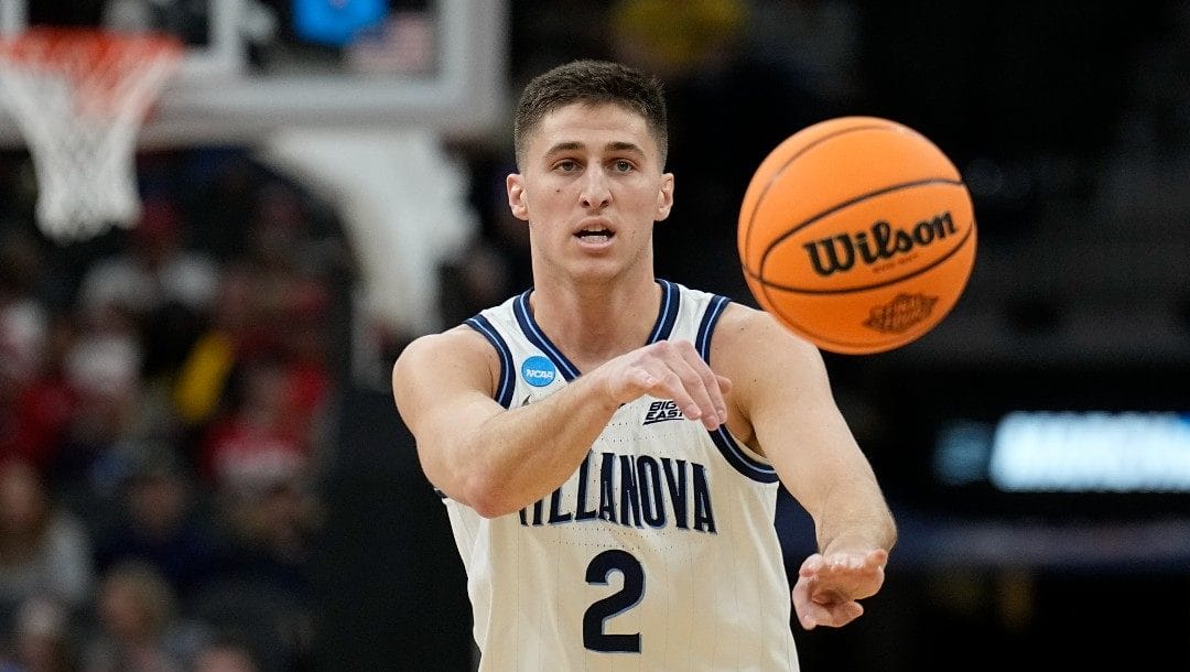 Villanova guard Collin Gillespie passes against Michigan during the first half of a college basketball game in the Sweet 16 round of the NCAA tournament on Thursday, March 24, 2022, in San Antonio.