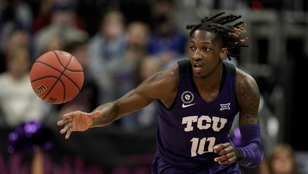 TCU guard Damion Baugh drives during the first half of an NCAA college basketball game against Kansas in the semifinal round of the Big 12 Conference tournament.