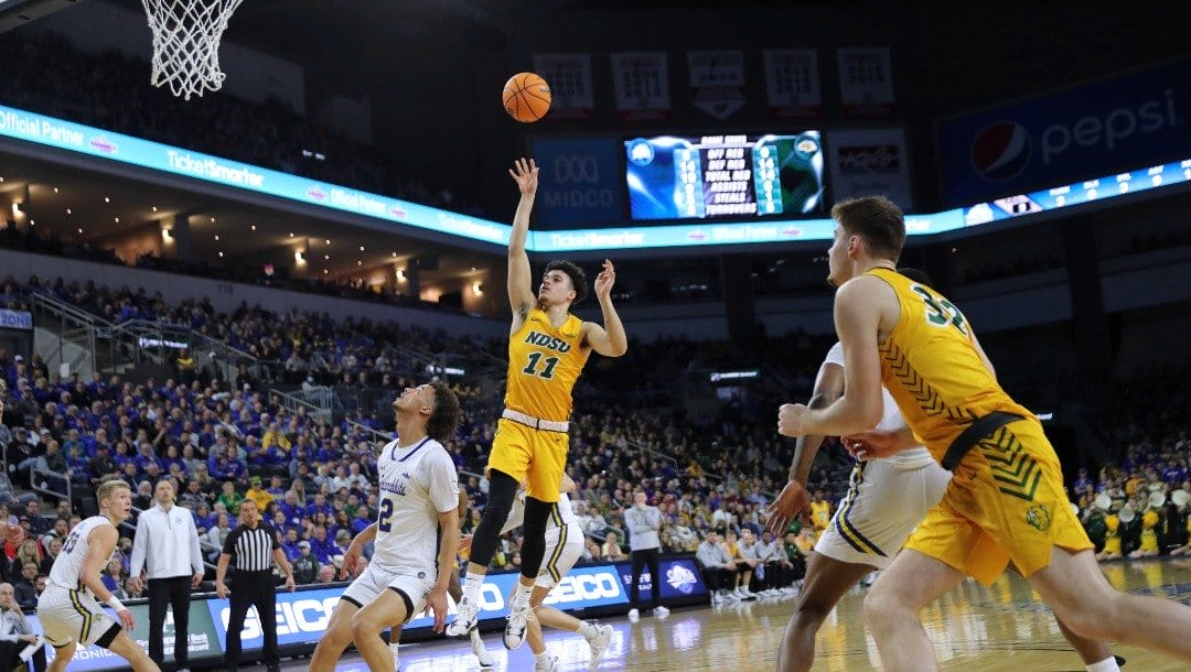 North Dakota State guard Jarius Cook (11) puts up a floater over South Dakota State's Zeke Mayo during the second half of an NCAA college basketball game for the Summit League men's tournament championship Tuesday, March 8, 2022, in Sioux Falls, S.D.