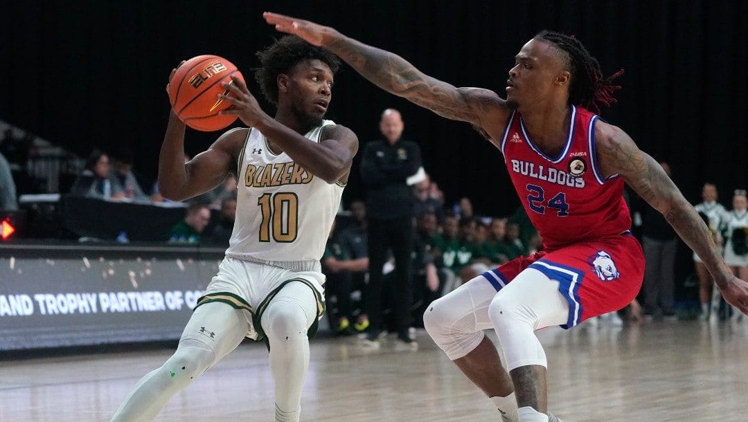 UAB guard Jordan Walker (10) is defended by Louisiana Tech guard Cobe Williams (24) during the first half of an NCAA college basketball game for the championship of the Conference USA men's tournament.