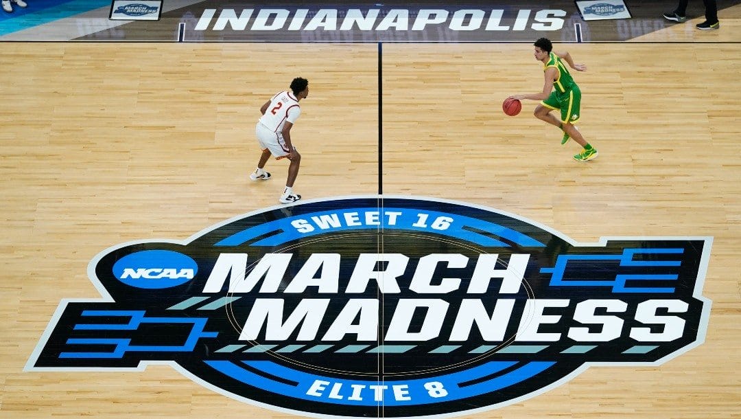 Oregon guard Will Richardson, right, drives up court in front of Southern California guard Tahj Eaddy (2) during the first half of a Sweet 16 game in the NCAA men's college basketball tournament at Bankers Life Fieldhouse in Indianapolis.
