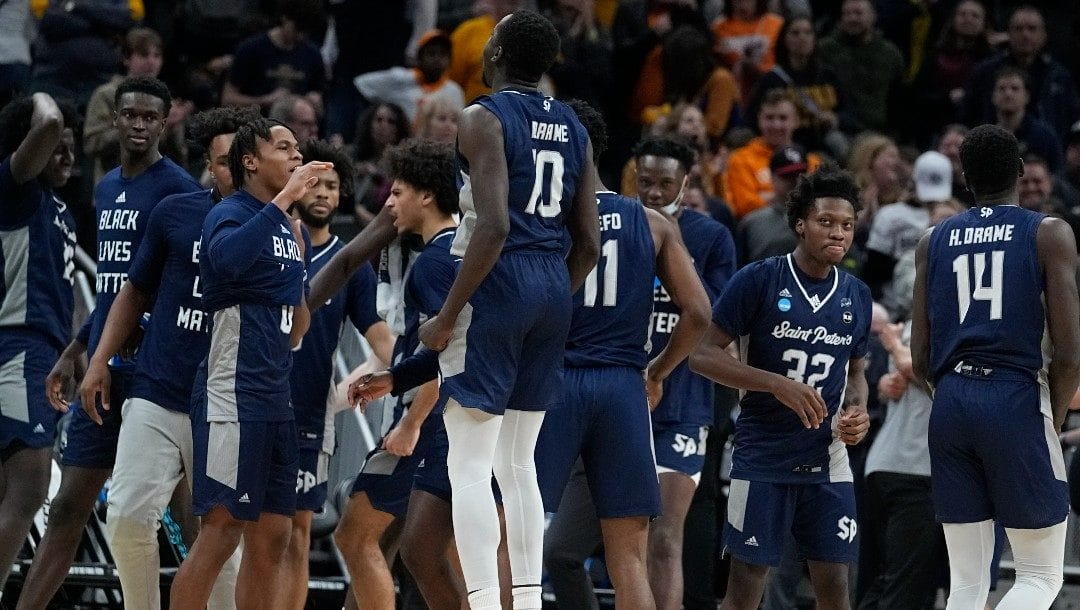 Saint Peter's players celebrate after defeating Murray State in a college basketball game in the second round of the NCAA tournament, Saturday, March 19, 2022, in Indianapolis.