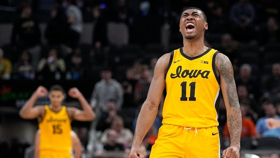 Iowa guard Tony Perkins celebrates at the end of an NCAA college basketball game against Purdue at the Big Ten Conference tournament.