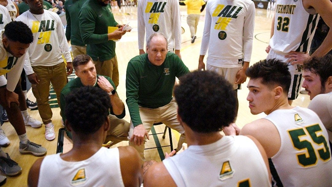 Vermont head coach John Becker talks to his team in the second half of an NCAA college basketball game for the America East Conference tournament championship, Saturday, March 12, 2022, in Burlington, Vt.