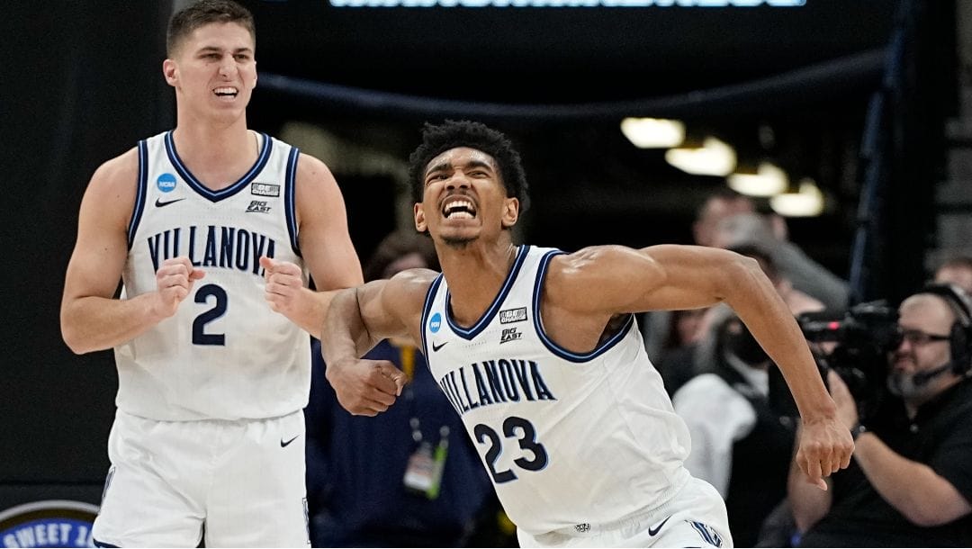 Villanova forward Jermaine Samuels, right, celebrates after scoring with guard Collin Gillespie, left, during the second half of a college basketball game against Michigan in the Sweet 16 round of the NCAA tournament March 24, 2022.