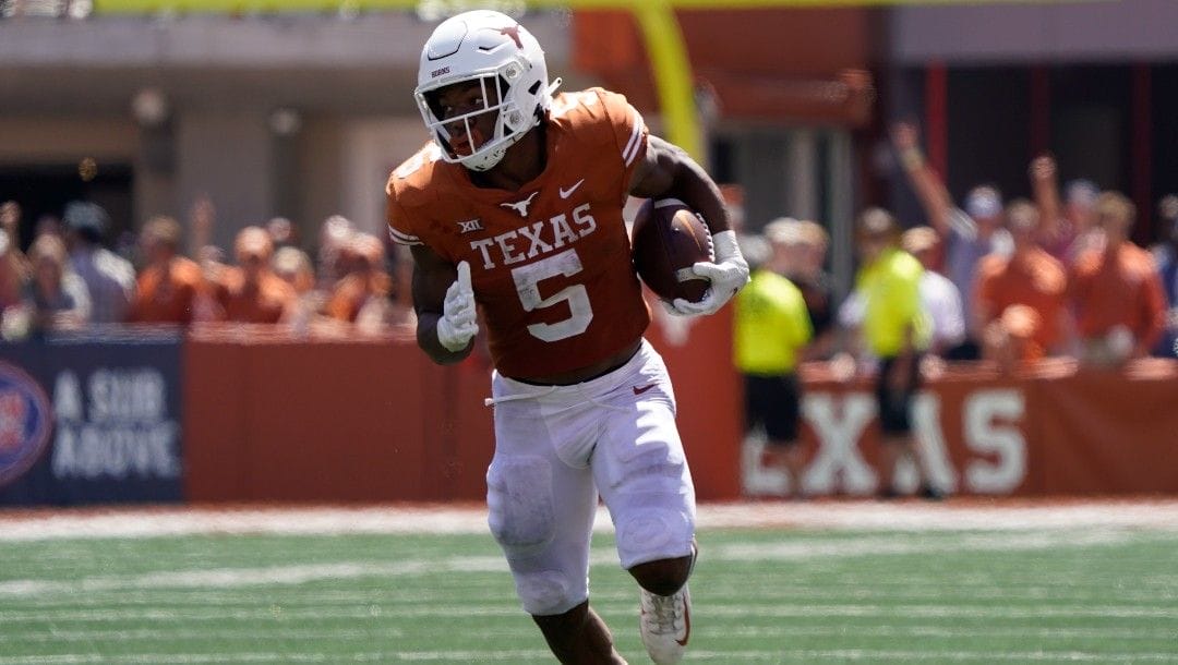 Texas running back Bijan Robinson (5) runs for a touchdown against Texas Tech during the second half of an NCAA college football game in Austin, Texas