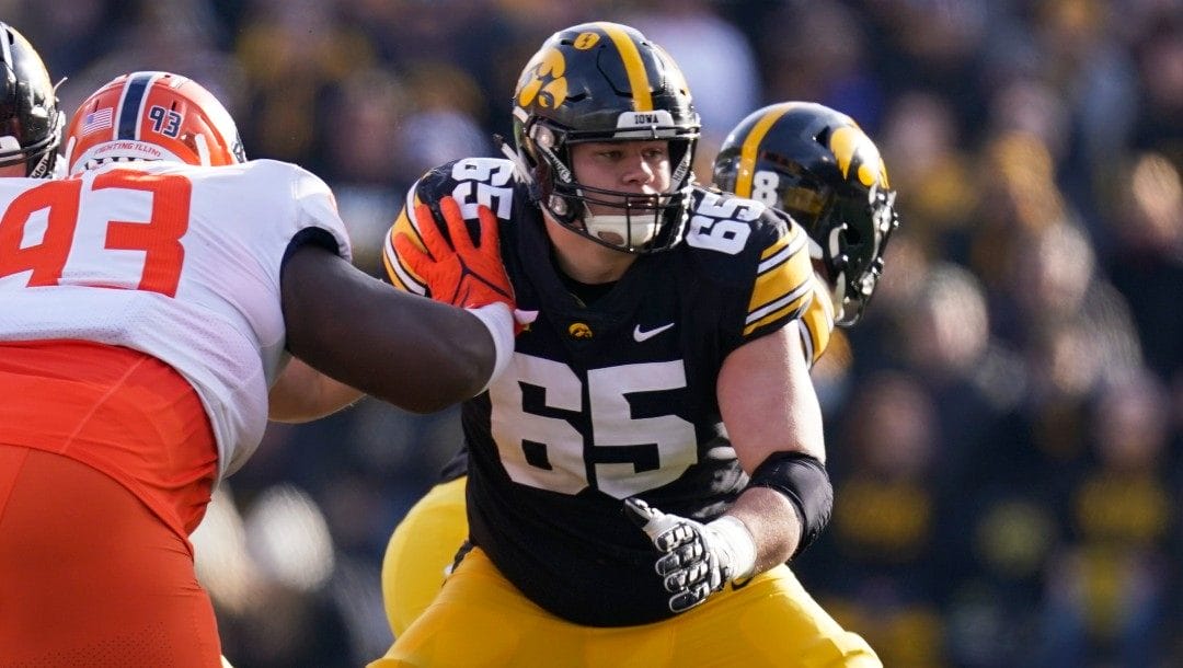Iowa offensive lineman Tyler Linderbaum (65) looks to make a block during the first half of an NCAA college football game against Illinois, Nov. 20, 2021, in Iowa City, Iowa.