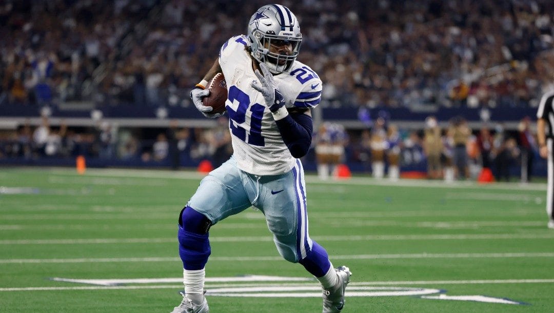 Dallas Cowboys running back Ezekiel Elliott (21) sprints to the end zone after catching a pass for a touchdown in the first half of an NFL football game against the Washington Football Team.