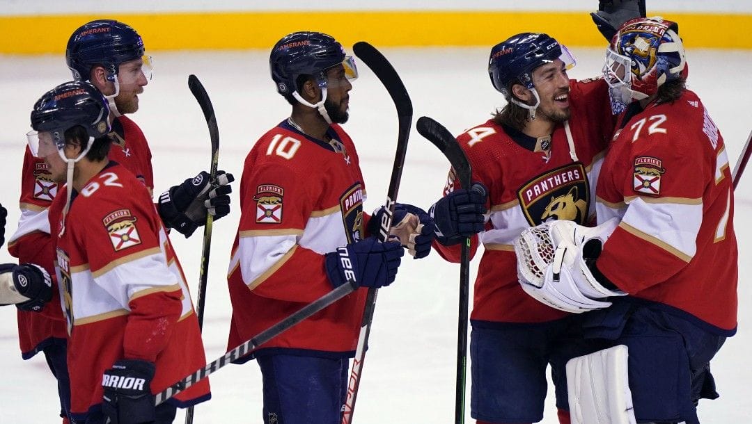 Florida Panthers left wing Ryan Lomberg, second from right, congratulates goaltender Sergei Bobrovsky (72) on a win over the Montreal Canadiens NHL hockey team Tuesday, March 29, 2022, in Sunrise, Fla.