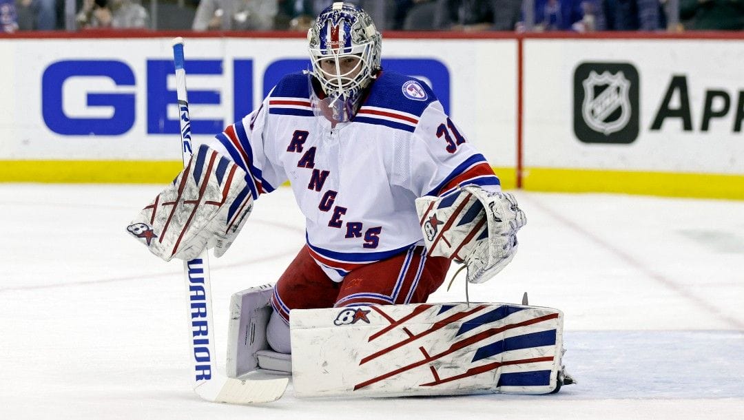 New York Rangers goaltender Igor Shesterkin (31) makes a save against the New Jersey Devils during the first period of an NHL hockey game Tuesday, March 22, 2022, in Newark, N.J.