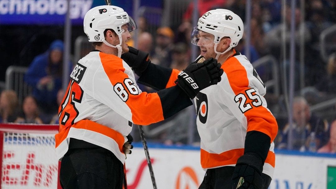 Philadelphia Flyers' Joel Farabee (86) is congratulated by James van Riemsdyk (25) after scoring during the third period of an NHL hockey game against the St. Louis Blues Thursday, March 24, 2022, in St. Louis.