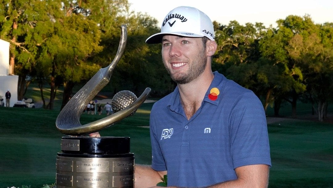 Sam Burns poses with the trophy after winning the Valspar Championship golf tournament Sunday, March 20, 2022, at Innisbrook in Palm Harbor, Fla.