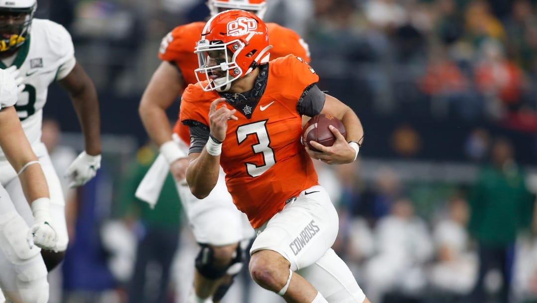 Oklahoma State quarterback Spencer Sanders (3) runs the ball in the second half of an NCAA college football game against Baylor for the Big 12 Conference championship in Arlington, Texas, Saturday, Dec. 4, 2021. (AP Photo/Tim Heitman)