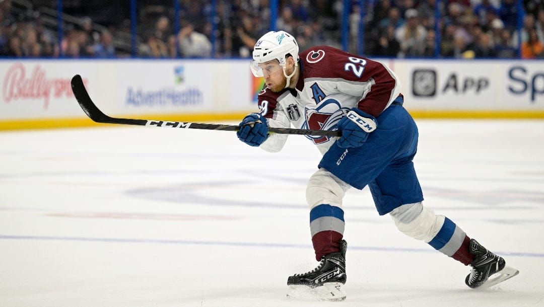 FILE - Colorado Avalanche center Nathan MacKinnon (29) attempts a shot during the second period of Game 3 of the NHL hockey Stanley Cup Finals against the Tampa Bay Lightning on Monday, June 20, 2022, in Tampa, Fla.