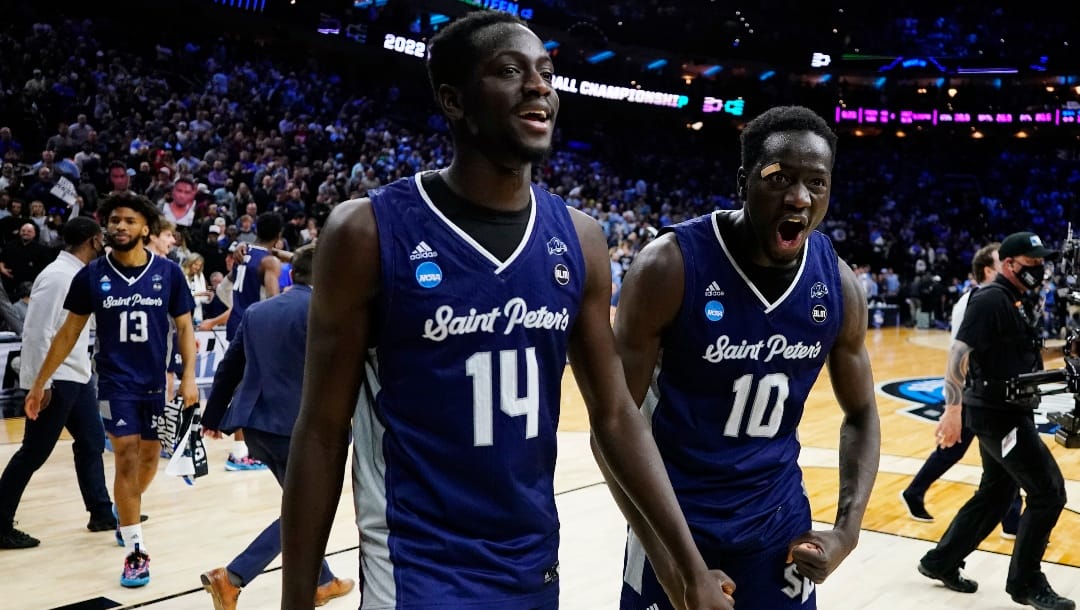 Saint Peter's Fousseyni Drame (10) and Hassan Drame (14) react after Saint Peter's won a college basketball game against Purdue in the Sweet 16 round of the NCAA tournament, Friday, March 25, 2022, in Philadelphia. (AP Photo/Chris Szagola)