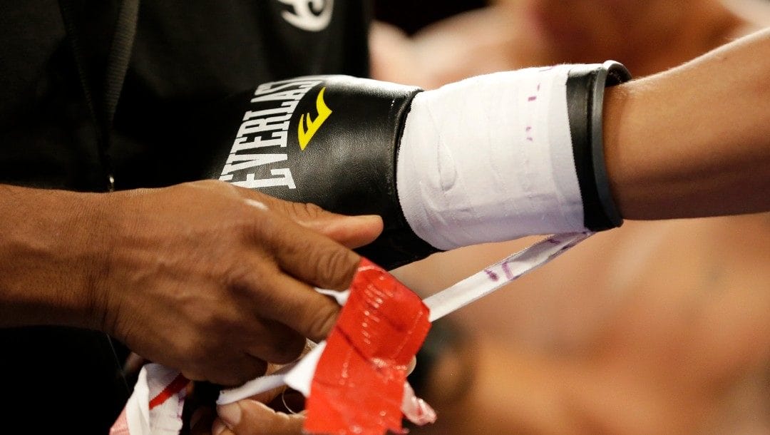 Dennis Galarza has his gloves untaped after he knocked out Cody Walker during a fight, Thursday, July 10, 2014 in Miami. Galarza knocked out Walker at 58 seconds of the first round.