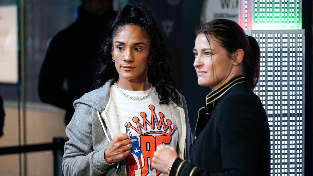 Boxers Amanda Serrano, left, and Katie Taylor pose for pictures in the lobby of the Empire State Building in New York, Tuesday, April 26, 2022. Taylor and Serrano will become the first two female fighters to headline a boxing match at Madison Square Garden when they fight on Saturday for the World Lightweight title.