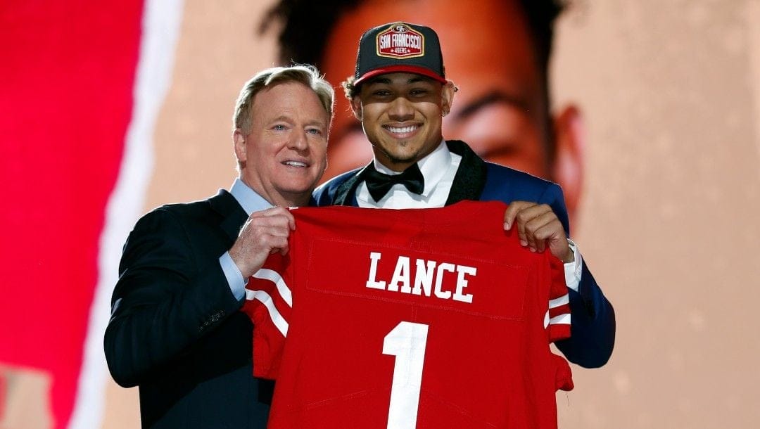 North Dakota State quarterback Trey Lance, right, holds a jersey with NFL Commissioner Roger Goodell after being chosen by the San Francisco 49ers with the third pick in the first round of the NFL football draft Thursday April 29, 2021, in Cleveland.