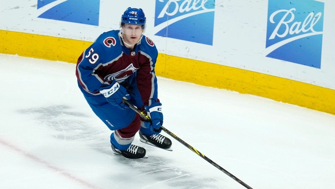 Colorado Avalanche center Ben Meyers (59) moves the puck in his first NHL game during the first period against the Carolina Hurricanes Saturday, April 16, 2022, in Denver.