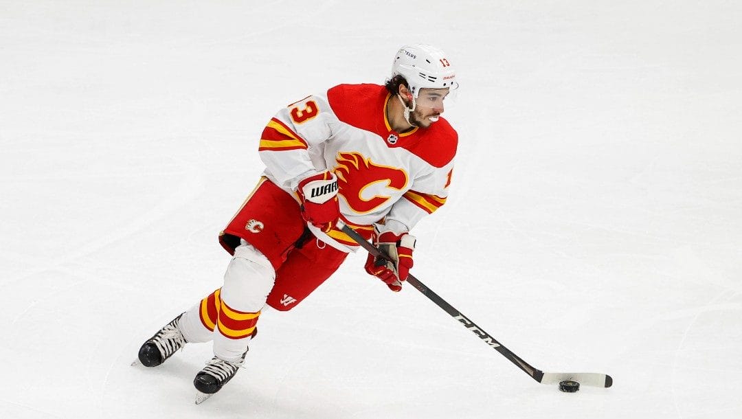 Calgary Flames left wing Johnny Gaudreau (13) looks to pass the puck against the Chicago Blackhawks during the first period of an NHL hockey game, Monday, April 18, 2022, in Chicago.