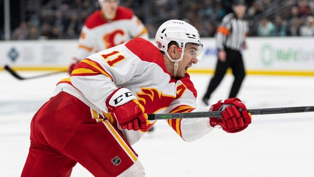 Calgary Flames forward Mikael Backlund takes a shot during an NHL hockey game against the Seattle Kraken, Saturday, April 9, 2022, in Seattle. The Flames won 4-1.